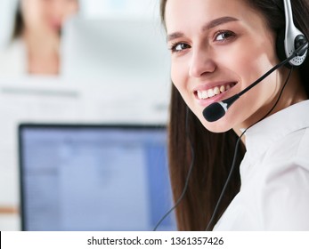 Smiling Businesswoman Or Helpline Operator With Headset And Computer At Office