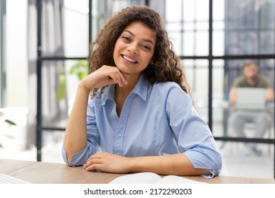 Smiling businesswoman looking at camera, make conference or business call, recording video blog, talking with client - Shutterstock ID 2172290203