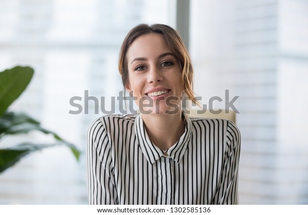 Smiling businesswoman looking at camera webcam
make conference business call, recording video blog, talking with
client, distance job interview, e-coaching, online training
concept, headshot
portrait