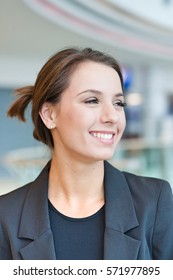 Smiling businesswoman looking off camera - Shutterstock ID 571977895