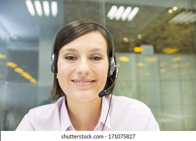 Smiling Businesswoman in the office on video conference, headset, point of view - Shutterstock ID 171075827