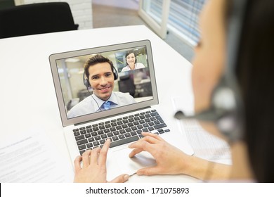 Smiling Businesswoman In The Office On Video Conference, Headset, Skype