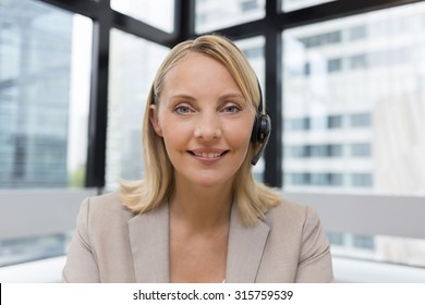 Smiling Businesswoman in the office on video conference, headset, point of view - Powered by Shutterstock