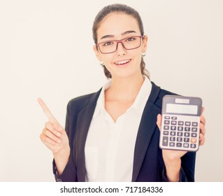Smiling businesswoman showing profit on calculator