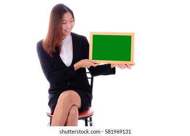 Smiling  businesswoman sitting and holding  green banner on white background.
