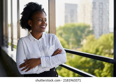 Smiling Businesswoman Standing At Office Terrace Looking Away