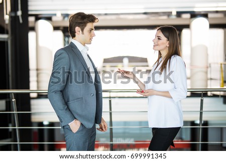 Smiling businesswoman telling something to her colleagues in the office