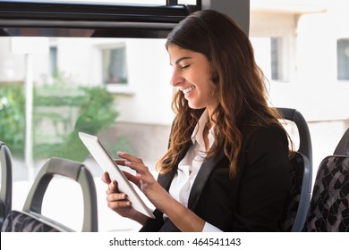 Smiling Businesswoman Using Digital Tablet While Traveling By Bus - Powered by Shutterstock