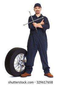 Smiling Car Mechanic With A Tire Isolated On White Background.