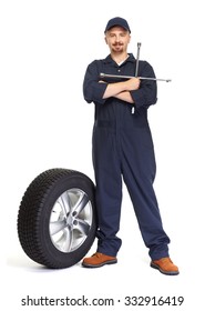 Smiling Car Mechanic With A Tire Isolated On White Background.