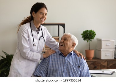 Smiling caring young female nurse comfort old Caucasian 80s male patient in private hospital. Happy woman doctor or GP support caress mature man client in clinic. Good medicine, healthcare concept. - Shutterstock ID 1997355554
