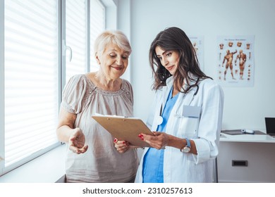 Smiling caring young female nurse doctor caretaker assisting happy senior grandma helping old patient in rehabilitation recovery at medical checkup visit, elder people healthcare homecare concept - Powered by Shutterstock