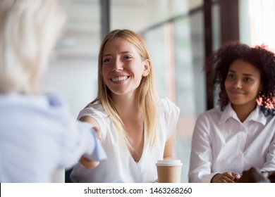 Smiling Caucasian female employee shake hand of colleague greeting get acquainted at company office meeting, positive businesswoman handshake business partner introducing or closing deal - Shutterstock ID 1463268260