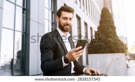 Smiling Caucasian Man Using Smartphone While Sitting At Office Desk, Business Concept