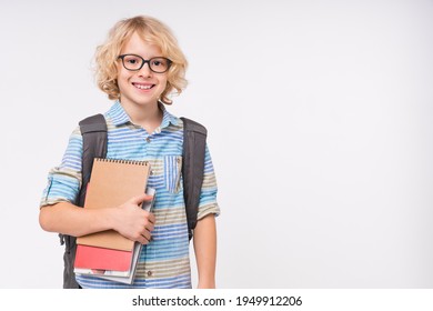 Smiling caucasian school boy holding textbooks isolated over white background - Shutterstock ID 1949912206