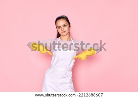 smiling caucasian woman in gloves pointing oneself with fingers