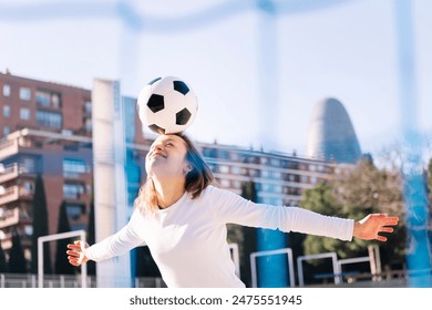 smiling caucasian woman head touching soccer ball - Powered by Shutterstock