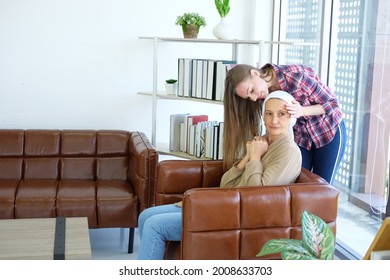 Smiling Caucasian Young Daughter Is Hugging Her Elderly Mother In White Headscarf After Chemotherapy Because She Is Suffering From Cancer Or Leukemia Patient.