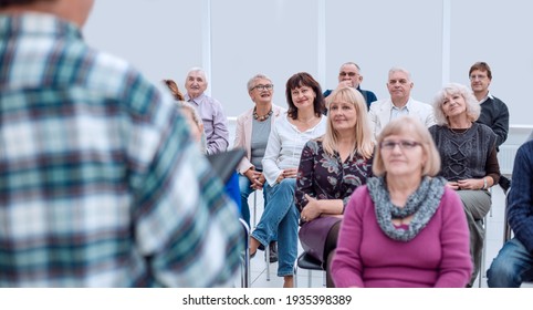 Smiling Charismatic Speaker Giving Public Presentation In Confer