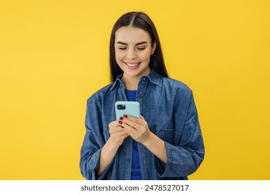 Smiling charming brunette woman uses mobile phone happy texting in social networks addicted to modern technologies - Powered by Shutterstock