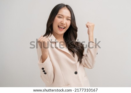 Smiling cheer up, attractive asian young woman, girl in beige suit formal dress, portrait elegant of pretty with long black hair, express happy fight to success
standing isolated on white background.