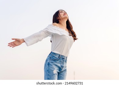 Smiling of cheerful beautiful pretty asian woman standing stretch her arms relax and enjoy with nature fresh air.asia beauty