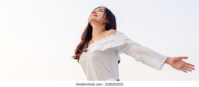 Smiling of cheerful beautiful pretty asian woman standing stretch her arms relax and enjoy with nature fresh air.asia beauty - Powered by Shutterstock