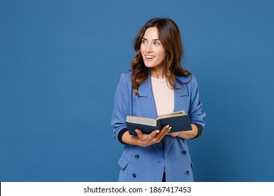 Smiling Cheerful Funny Beautiful Attractive Young Brunette Woman 20s Wearing Basic Jacket Hold In Hands Reading Book Looking Aside Isolated On Bright Blue Colour Wall Background Studio Portrait