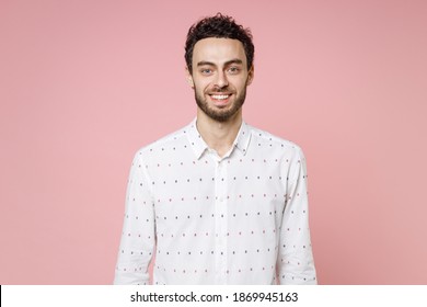 Smiling Cheerful Funny Handsome Attractive Young Bearded Man 20s Wearing Basic Casual White Shirt Standing And Looking Camera Isolated On Pastel Pink Color Background Studio Portrait