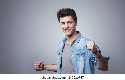 Smiling Cheerful Guy Showing Fists With Playful Attitude