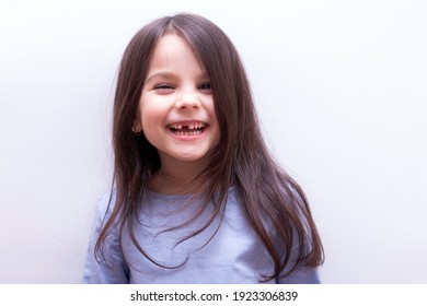 Smiling cheerful little girl with no tooth on white background