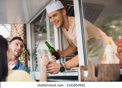 Smiling Chef Giving Drinks To Customers From Food Truck