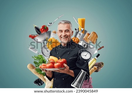 Smiling chef surrounded by food ingredients and professional kitchen utensils: restaurants and creative cooking concept
