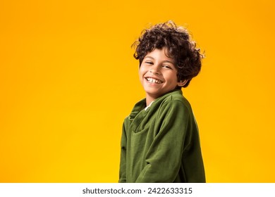 Smiling child boy over yellow background. Positive emotions concept - Powered by Shutterstock