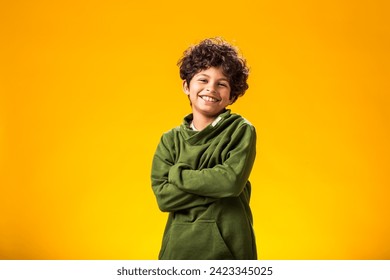 Smiling child boy over yellow background. Positive emotions concept - Powered by Shutterstock