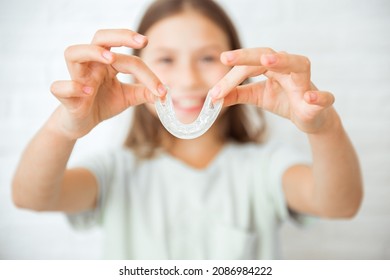 Smiling Child Girl With Healthy Teeth Using Removable Braces Or Aligner For Straightening And Whitening Teeth. Orthodontic Treatment For Correction Of Bite