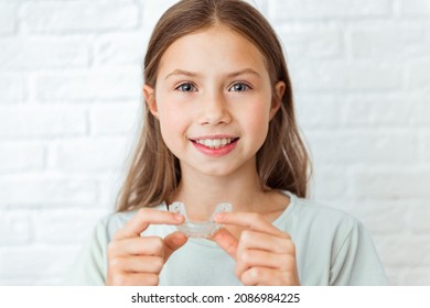 Smiling Child Girl With Perfect And Healthy Teeth Using Removable Braces Or Aligner For Straightening And Whitening Teeth. Orthodontic Treatment For Correction Of Bite