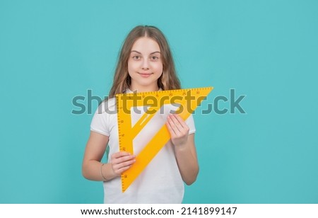 smiling child with math triangle measuring tool