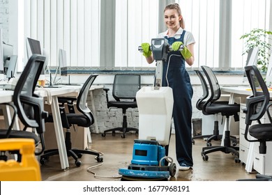 Smiling Cleaner Washing Floor In Office With Cleaning Machine