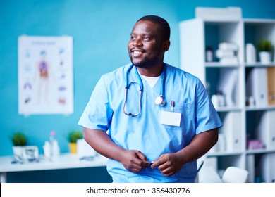 Smiling Clinician In Hospital Looking Aside