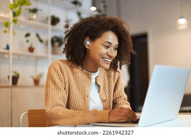 Smiling confident African American woman, a call center worker with earphones having online conference by video link on laptop, consulting clients from a modern office. People. Career. Online job - Shutterstock ID 2261942327