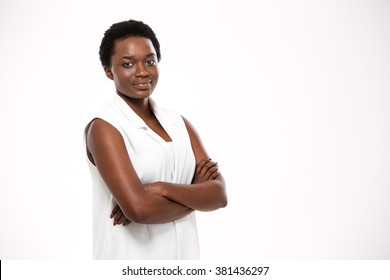 Smiling Confident African American Young Woman Standing With Arms Crossed Over White Background