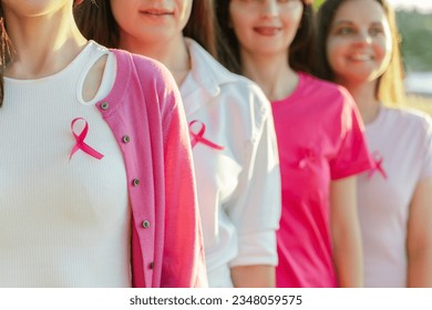 Smiling confident beautiful  women wearing  t shirts with breast cancer pink ribbon standing on the street. Health care, support, prevention. Breast cancer awareness month concept - Shutterstock ID 2348059575