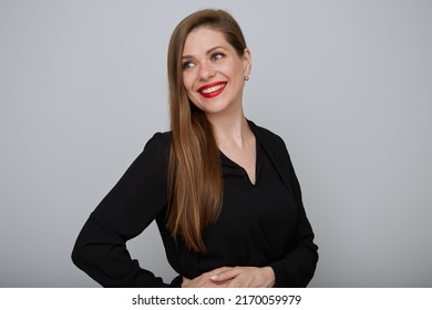 Smiling Confident Business Woman Or Office Worker In Black Suit Holding Hands On Hip And Looking Away, Isolated Female Portrait.