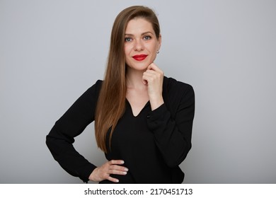 Smiling Confident Business Woman Or Office Worker In Black Shirt Holding Hands On Hip And Touching Her Chin, Isolated Female Portrait.