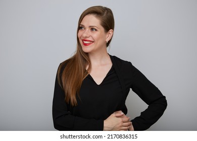 Smiling Confident Business Woman Or Office Worker In Black Suit Holding Hands On Hip And Looking Away, Isolated Female Portrait.