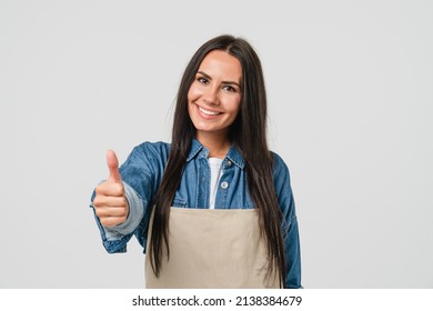 Smiling Confident Caucasian Female Woman Barista Bar Tender In Apron Selling Coffee Tea Hot Beverage Showing Thumb Up Isolated In White Background. Takeaway Food.