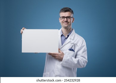 Smiling Confident Doctor Holding A Blank White Sign