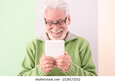 Smiling Confident Male With A Digital Tablet Held In His Hands Standing On Cute Background. White-haired Mature Caucasian Man With Glasses, College Student Of The Third Age University