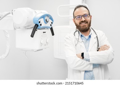 Smiling Confident Radiologist Standing Near X-ray Equipment. High Quality Photo